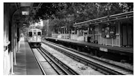 a black and white photo of a train at a station