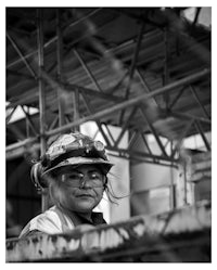 a black and white photo of a construction worker