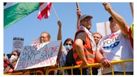 a group of people holding signs and flags